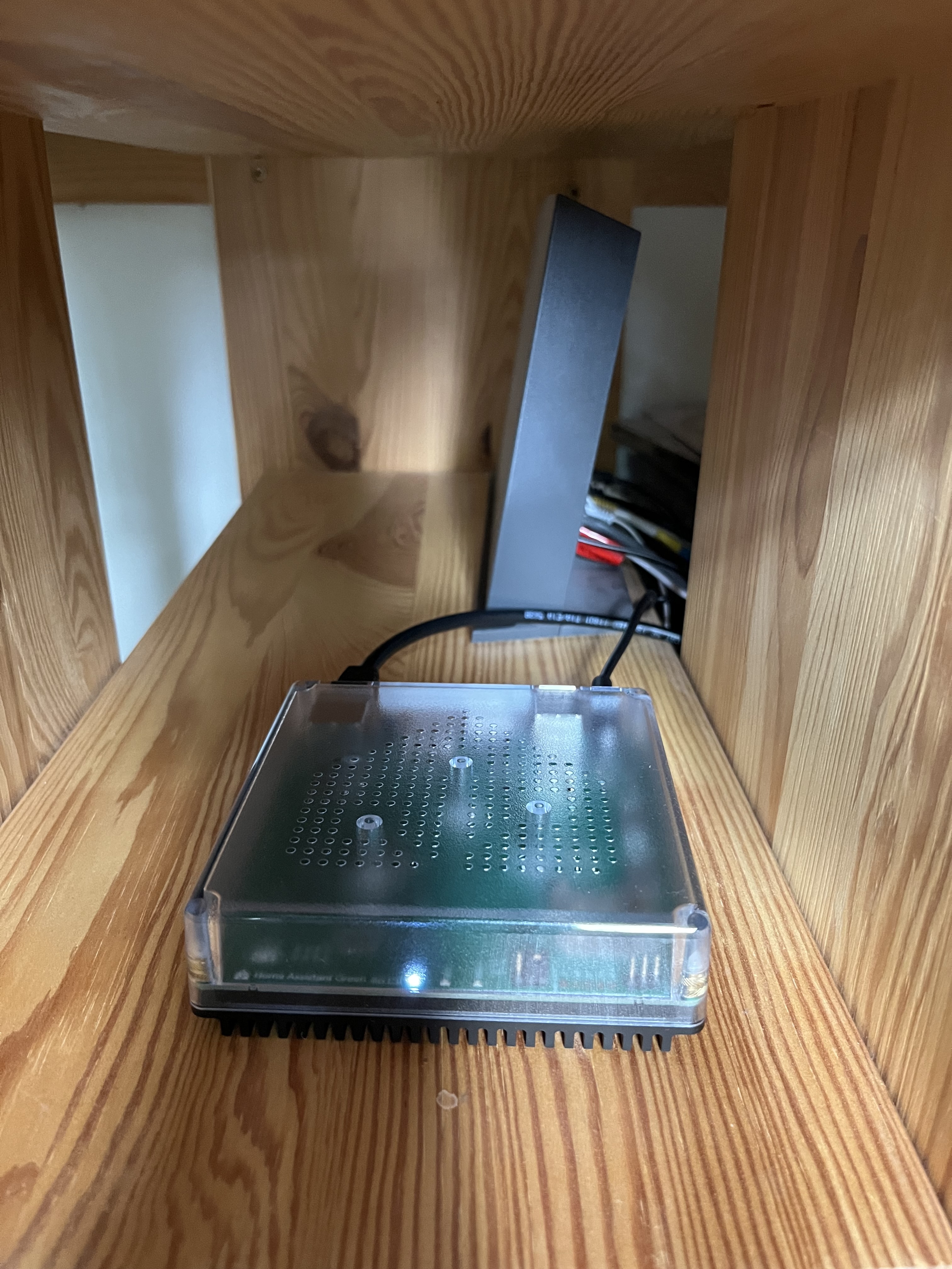 Home Assistant Green in situ, in front of router
