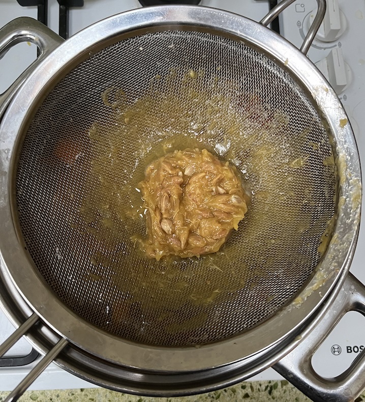 Sieve with pips and stringy bits of membrane left